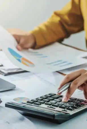 woman calculating and looking at graph