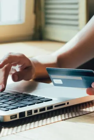 credit card and typing on computer